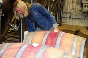 ©™2013 Blue Ridge Life: Photos By BRL Mountain Photographer Paul Purpura : Emily Pelton, winemaker at Veritas Vineyard and Winery in Afton inspects one of the two barrels she supplied to Wild Wolf earlier this week as part of a special collaborative brew using kombucha cultures, additional barrels from Pollak Vineyards, and the gang at Barefoot Bucha. 