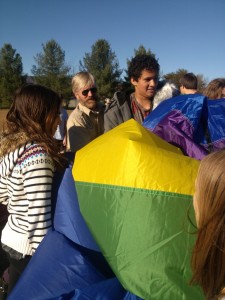 Caroline Lancaster, Scott Cohrs, Kahlil Banning,and other students wrestle the balloon back into its pack.