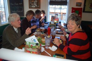 A group enjoys breakfast, including waffles from the new waffle and fruit bar this past Sunday morning. 
