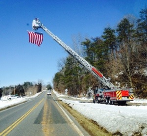 Copyright 2014 Blue Ridge Life: Photo By Tommy Stafford - Above the US Flag flies over Route 151 in Afton in memory of slain Waynesboro Police Reservist Kevin Quick. After a public memorial service in Charlottesville on Monday, a private family ceremony was held in Nelson.