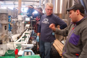Danny Wolf (far right) brewmaster at Wild Wolf talks about the canning of beers taking place Wednesday afternoon with the crew from Old Dominion Mobile Canning.  