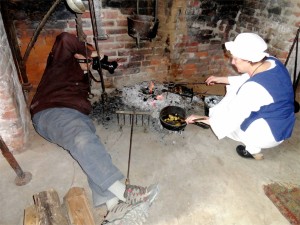 Photo courtesy of Foxie Morgan : BRL Shenandoah Valley Photographer Norm Shafer literally gets in the fire to grab this shot of a fireplace cook demonstration at Pharsalia. This is one of the many things folks can expect to see from a time when Pharsalia was first established 2 centuries ago. 