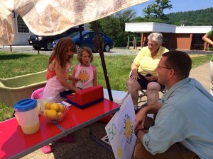 Photo Courtesy of Jackie Britt: Lovingston Attorney Daniel Rutherford stops to chat it up with youngsters Molly & Natalie Lynch. They have been selling lemonade on Front Street in Lovingston during the hot days. 