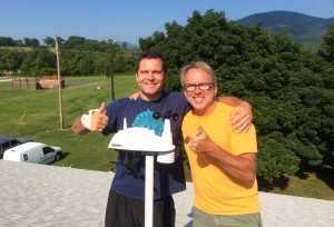 ©2014 Blue Ridge Life : Photo By Henri Weems : Will Trager (left) owner of Trager Brothers Coffee and Tommy Stafford, publisher of Blue Ridge Life Magazine (and weather geek) stand on the roof of the Rockfish Valley Community Center Monday morning - July 7, 2014, after completing the  of the latest station in the BRL Weather Network. The weather station will be online soon and then you'll be able to see real time weather conditions from the Rockfish Valley of Nelson. 