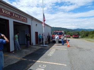 Photo Courtesy of Faber VFD : Volunteers, members and guests show honor this past September 11, 2014 during a ceremony to dedicate a new flagpole at their fire station in Faber. The flag flew at half staff in remembrance of those lost during 9-11.  