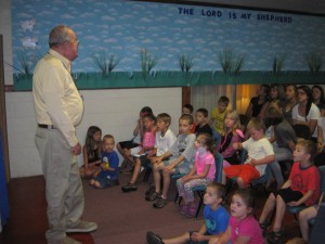 Photo Courtesy of Piney Mountain Ministries Facebook Album : Mr. Robert Mansfield on July 21, 2014 during Vacation Bible School speaking with children. 