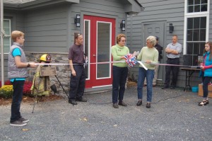 Flanked by Frank Ott's grandchildren on the far right and left, Wintergreen F&R Chief Curtis Sheets L) looks on as Julia Rogers (Nelson Chamber President - center) and Nelson BOS Chair Connie Brennan cut a ribbon officially dedicating the newly renovated fire station in the late Frank Ott's name. 