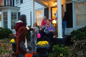 ©2014 Blue Ridge Life : Photos By Tommy Stafford : BRL Publisher Yvette Stafford with the Junior & Juniorette Publishers in tow, thanks one of the dozens of people in Lovingston that rolled out the red carpet for trick or treaters this past Friday night - October 31, 2014