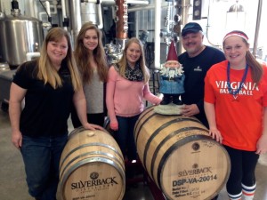 Photo Courtesy of Christine Riggleman : A celebrity of sorts made a stop in Afton at Silverback Distillery on Saturday afternoon. The Travelocity Gnome hopped atop one of the aging barrels there to meet and greet with the entire gang at Silberback. 