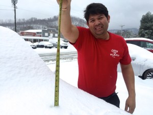©2015 Blue Ridge Life : Photo By Tommy Stafford : Elmer Brito of Margaratis Restuarant in Nellysford hold up a tape measure Thursday afternoon - March 5, 2015 showing about 5" of snow on his pickup truck hood. Other areas received between 7-12".