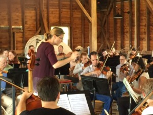 Photo by BRLM Mountain Photographer Paul Purpura : Artistic director Erin Freeman conducts members of the Wintergreen Summer Music Academy and locals who joined in the music in the Rodes Farm Barn, Saturday - July 25, 2015.