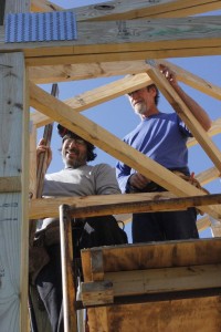 Paul Ackerman and Brian Webb work on part of the framing of the roof at what will become the Blue Mountain Pavilion at RVCC. 