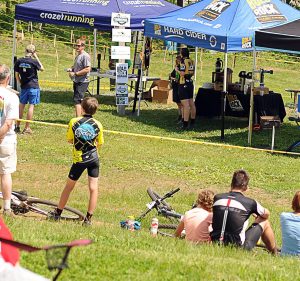 Photo By Paul Purpura : Woody Elliott, (upper left in sunglasses) Race Coordinator for the Tread & Trail Series at Wintergreen, chats it up with a participant this past weekend at Wintergreen Resort. About 100 people took part in the two day series.