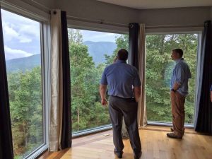 Photo Courtesy of Dima Holmes - Wintergreen Real Estate Company : Will Fenton (left) shows Ben Holmes of Nellysford one of the spectacular views looking toward the mountains from one of the bedrooms. Wednesday - August 17, 2006