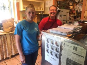 Not to worry, Kristin Hill (left) and Clara Wilson are two of the staff behind at Basic Necessities taking care of things while the other crew is in France.  