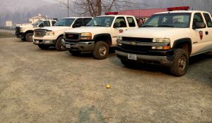 Virginia Department of Forestry trucks are lined up at the Command Post on Eades Lane Thanksgiving morning with smoke hanging in the air. The battle again a wildfire that started last weekend continues on Thanksgiving day. November 24, 2016.