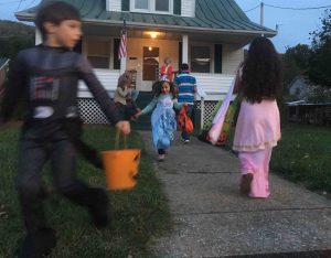 ©2016 Blue Ridge Life Magazine : Photos By Tommy Stafford : Junior Publisher Adam Stafford (left) races from one house to the next with sister and Juniorette Publisher Peyton Stafford (middle as Elsa) during the annual Halloween celebration held in Lovingston this past Monday evening - October 31, 2016. 