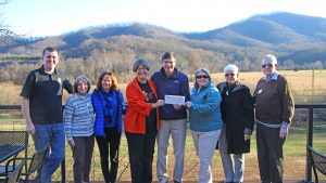 Photo Courtesy of Wintergreen Resort : Pictured l. to r.: Lindsay Dorrier III, Sue Love, Donna McCurdy, Jane Francie, Hank Thiess, Rudy Strickland, Ika Joiner and Joe Steele are all smiles as a check for $3379.41 is presented to the Nelson County Community Fund last week on December 8, 2016. 