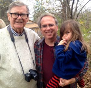 Photo By Woody Greenberg : Earl Hamner, Jr. and BRL Publisher Tommy Stafford (along with a pouty Peyton Stafford) stop for a shot on the front sidewalk of Hamner's boyhood home in Schuyler in April 2014. He was back in his hometown during the filming of a biography on his life. Hamner wrote for many columns for this very magazine in our early days as well. 