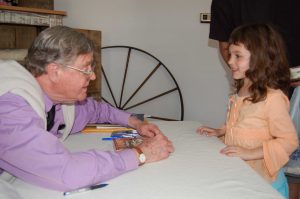 Photo By Tommy Stafford : Earl Hamner, Jr. chats it up with one of his youngest fans during a visit back to his hometown of Schuyler, Virginia 10 years ago in March of 2007. 